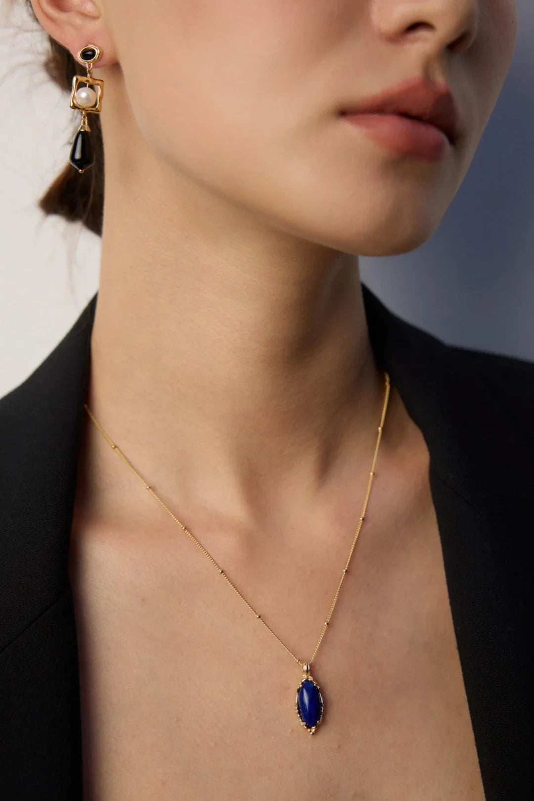 Anaïs & Aimee's Baroque Pearl Necklace layered with delicate gold chains, highlighting timeless elegance. Perfect for UK jewelry lovers seeking modern London