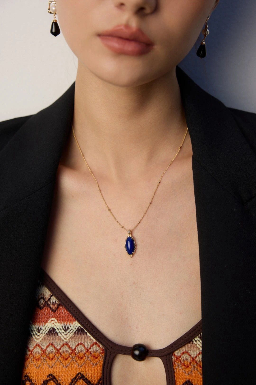 Close-up of Ancient Sky Stone Celeste necklace with blue lapis lazuli on gold chain