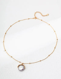 pearl pendant necklace UK close up gold minimalist jewellery natural pearl