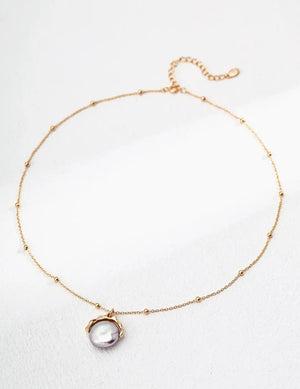 pearl pendant necklace UK close up gold minimalist jewellery natural pearl