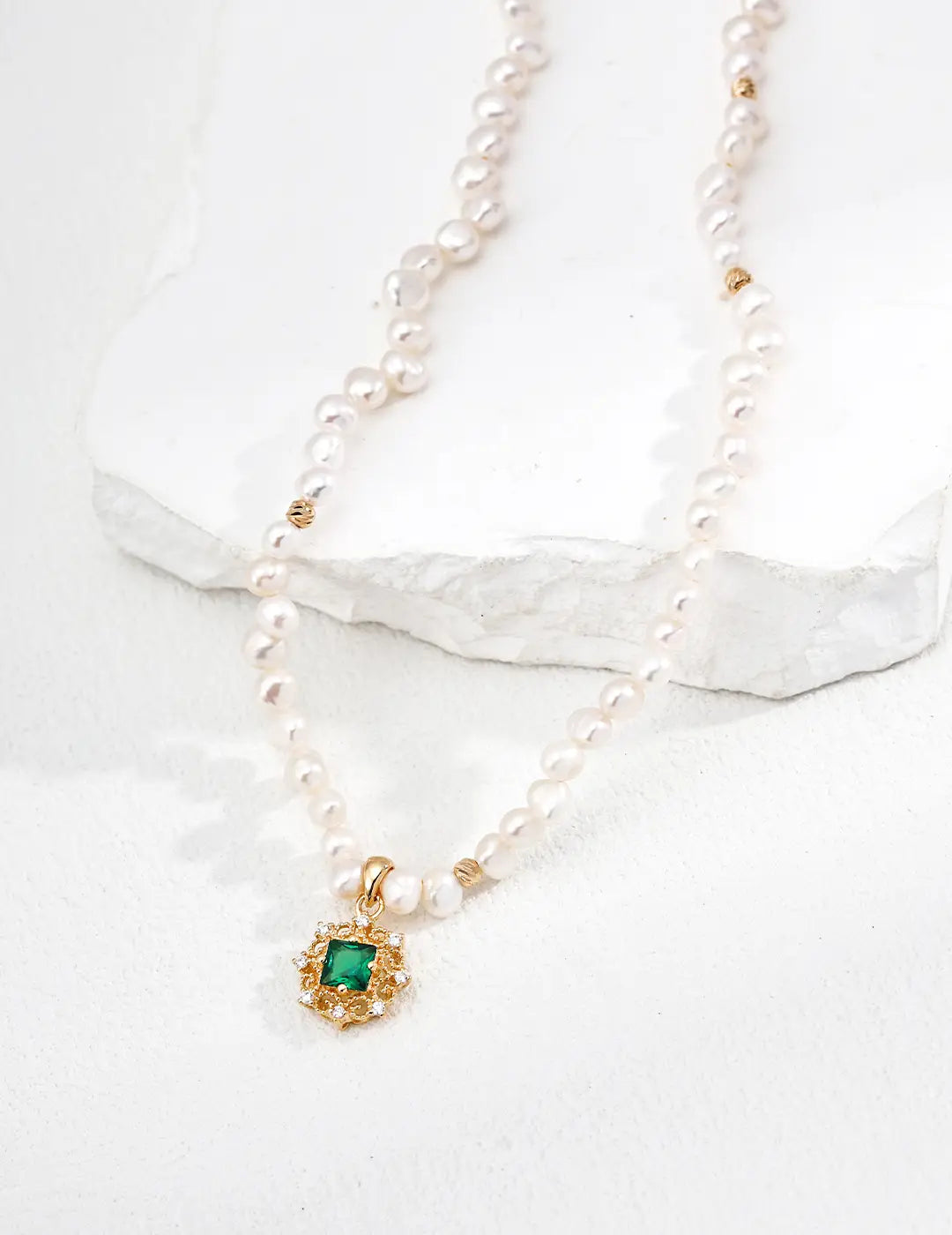 Pearl necklace UK close-up – CZ halo green pendant detail