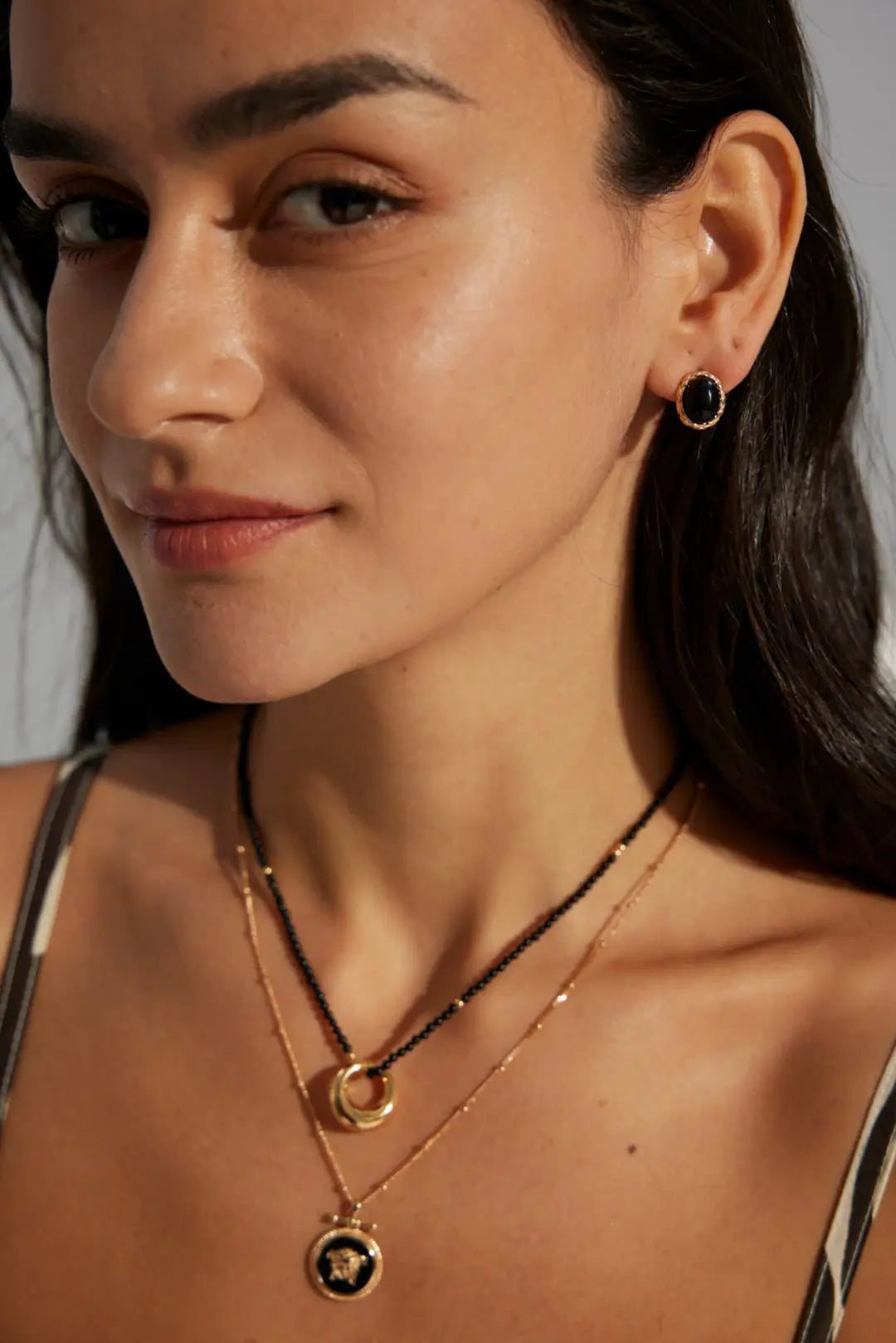 Close-up of Anaïs & Aimee Black Obsidian earrings on model with sleek modern design