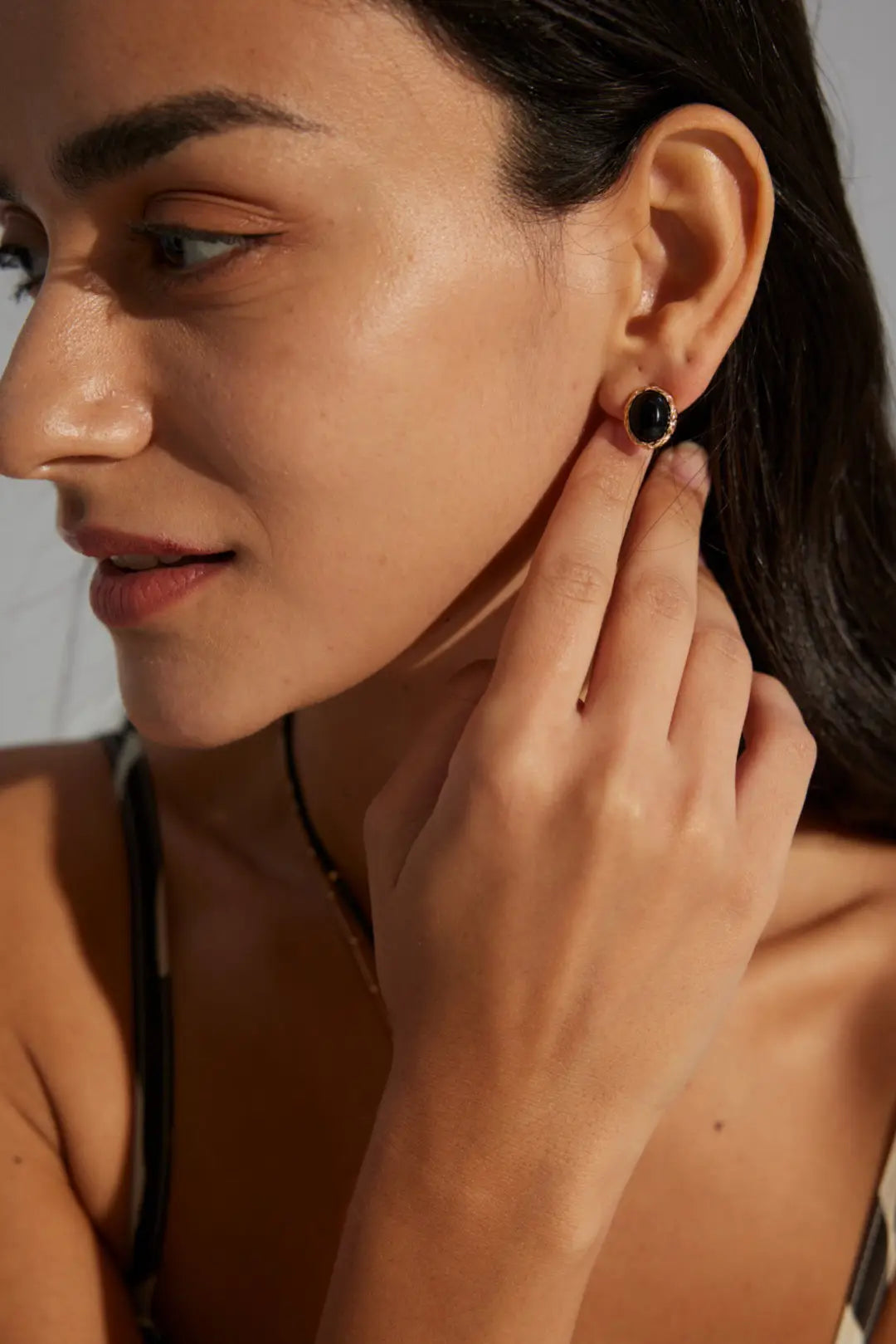 Anaïs & Aimee modern Black Obsidian earrings on model’s side profile, elegant style