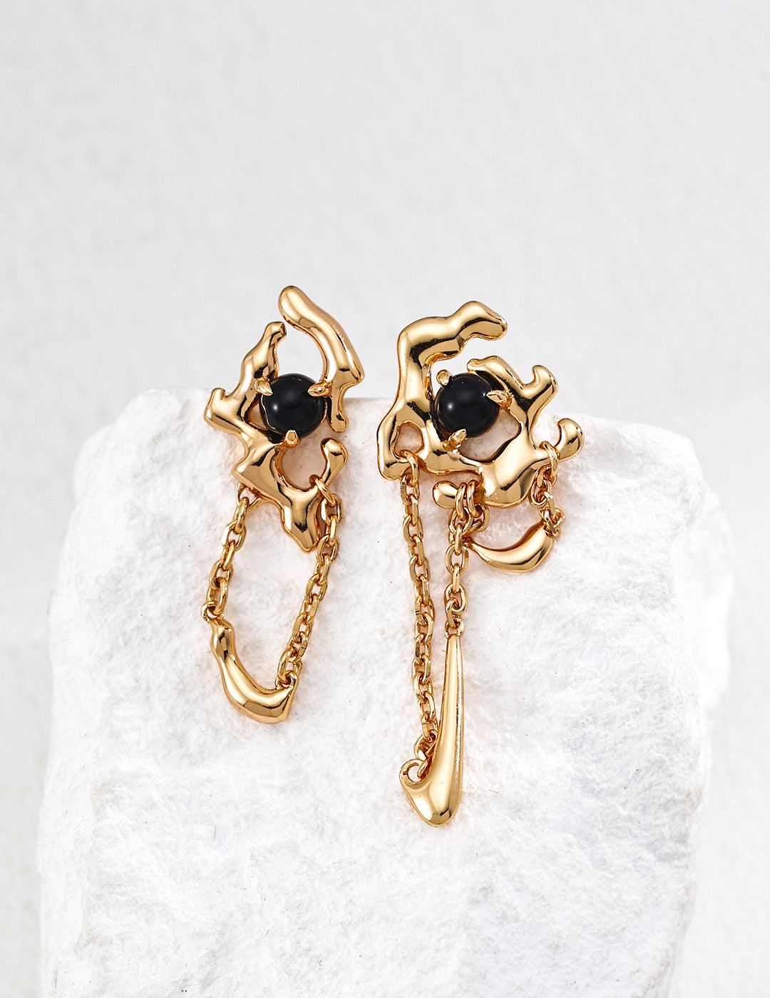 Black agate chain earring in vintage gold, featuring sculptural sterling silver design with flowing metal and organic chain detail