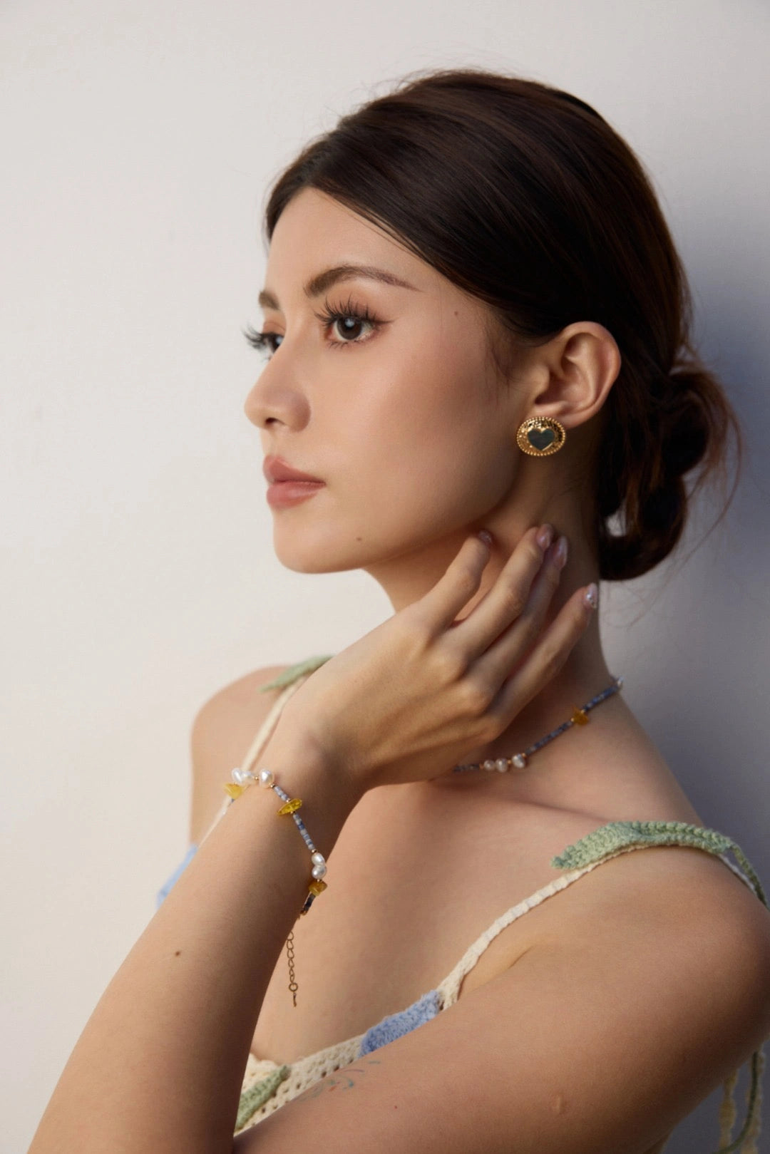 Model wearing Celeste Harmony bracelet and necklace with pearls and blue sodalite.