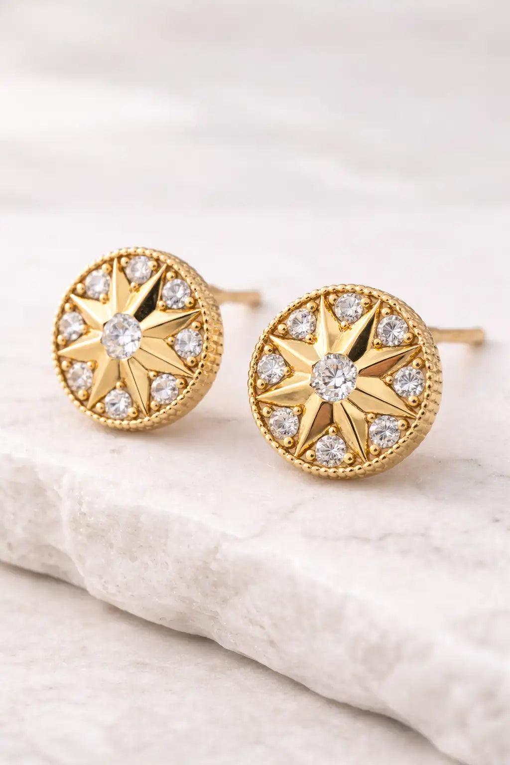 Didcot Gold Earrings with star design on a light background