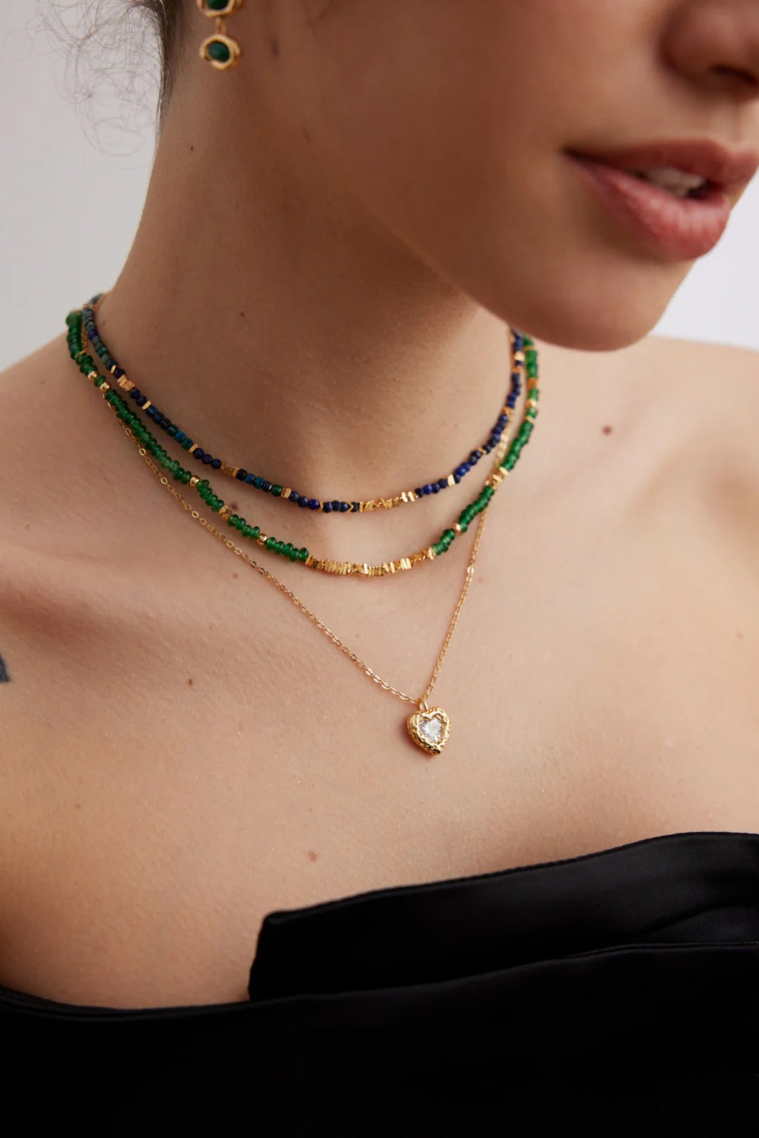 Close-up of Anaïs & Aimee Emerald Green Choker with gold stones and adjustable chain