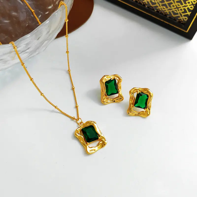 Emerald crystal stud earrings and matching gold-tone necklace with green gemstones