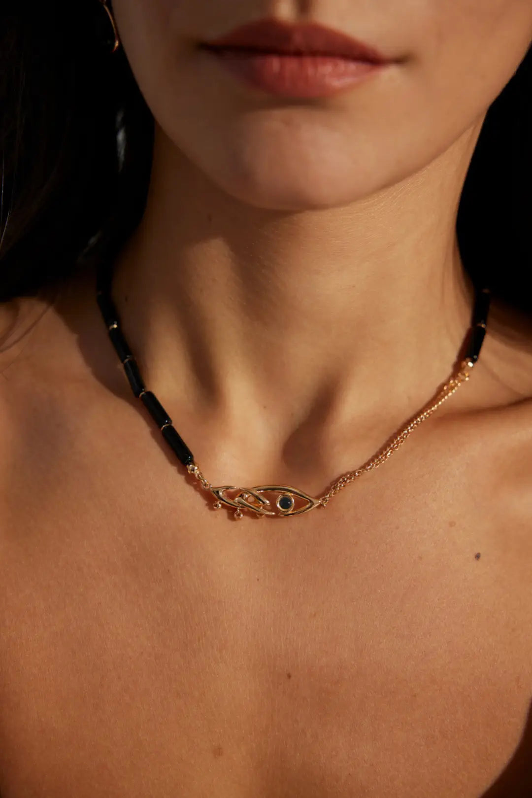 Close-up of Anaïs & Aimee gold Evil Eye Black Obsidian Necklace with intricate design