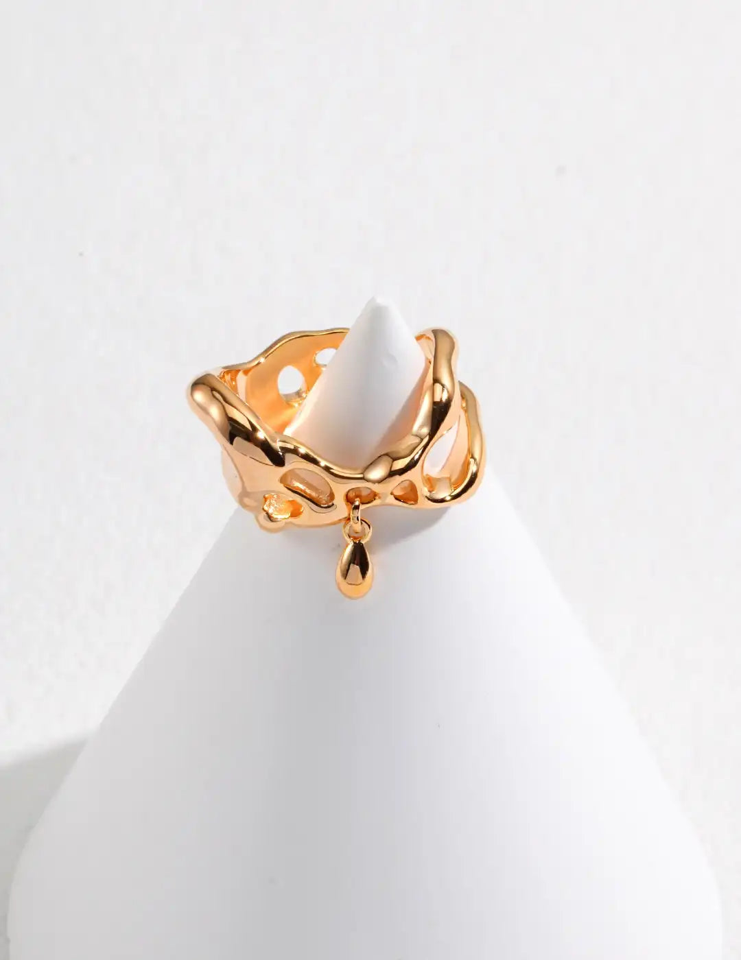 Gold sculptural adjustable ring UK with modern fluid openwork detail