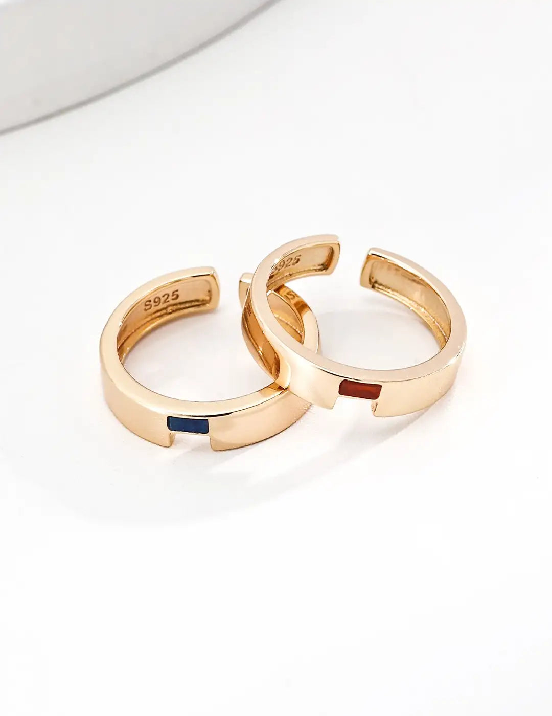 Two gold hoop earrings on a white background