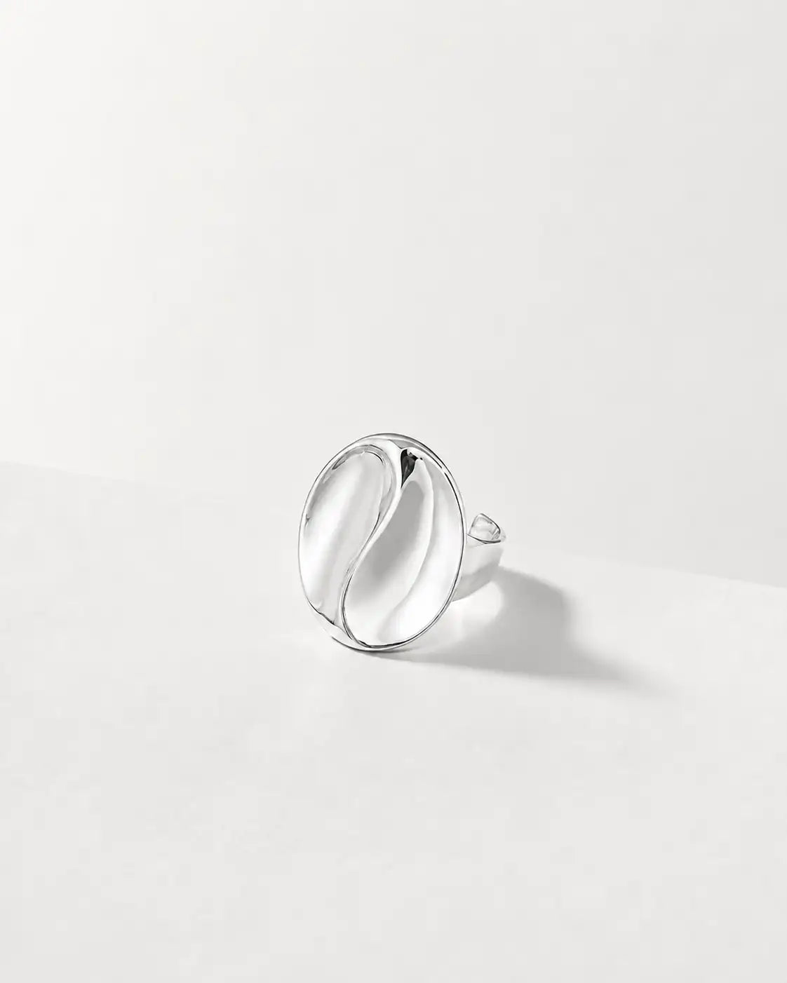 Silver ring on a light gray background