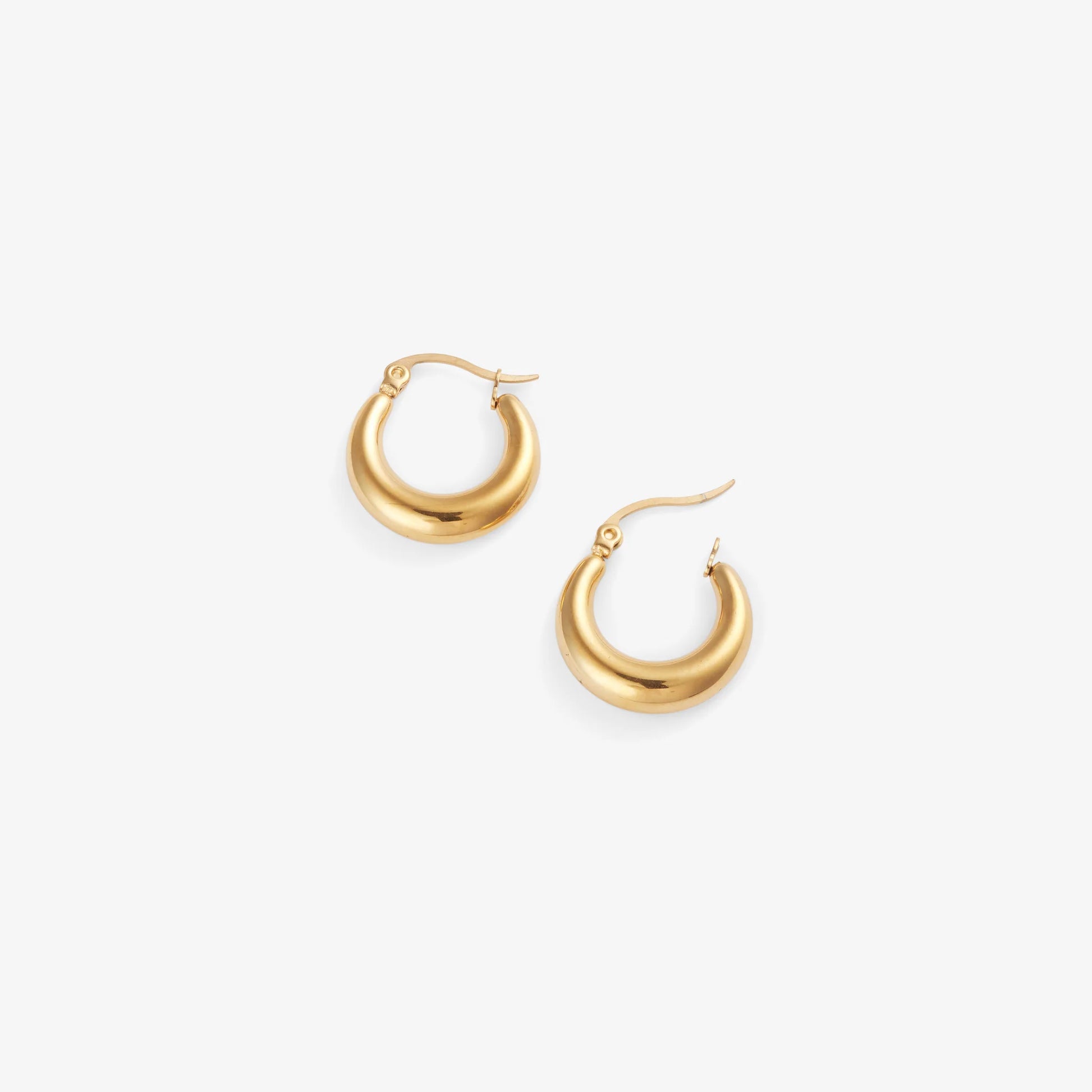 Gold hoop earrings on a white background