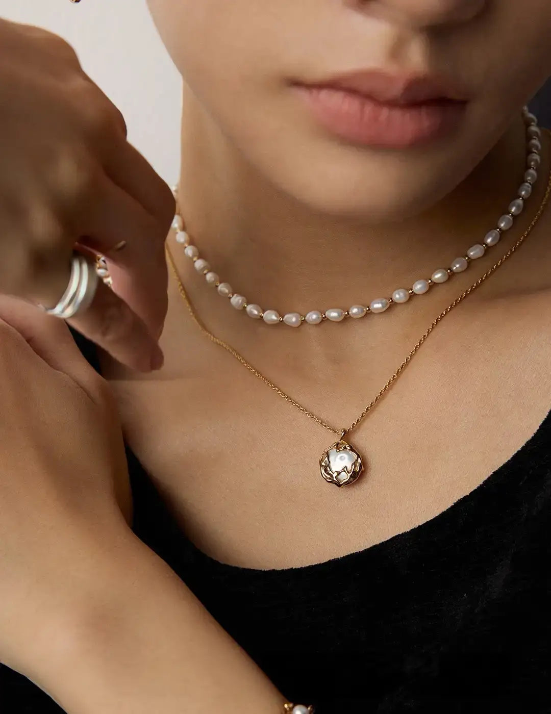 Model wearing gold pearl pendant necklace UK layered with freshwater pearl choker