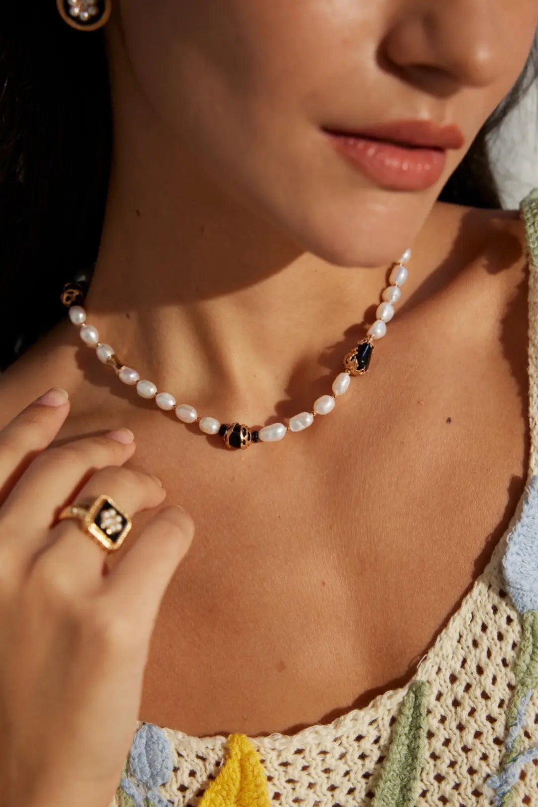 pearl gemstone necklace UK worn with gold accessories