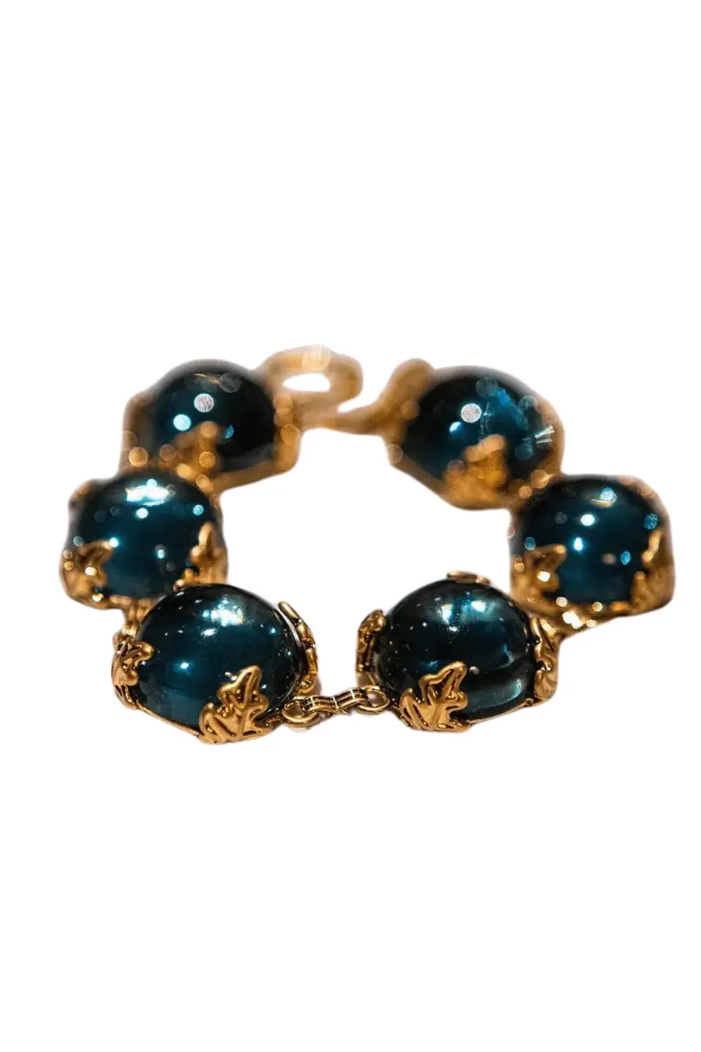Patchouli Bristol Blue Glass Bracelet with deep blue stones and intricate gold leaf design.