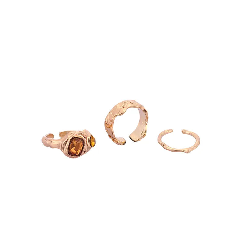 Trio adjustable gold ring set with amber stone, hammered, and wavy designs