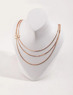 gold necklace on a white mannequin bust