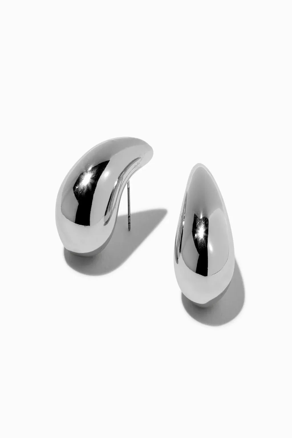 Sterling silver sculptural stud earrings with high-shine finish on white.