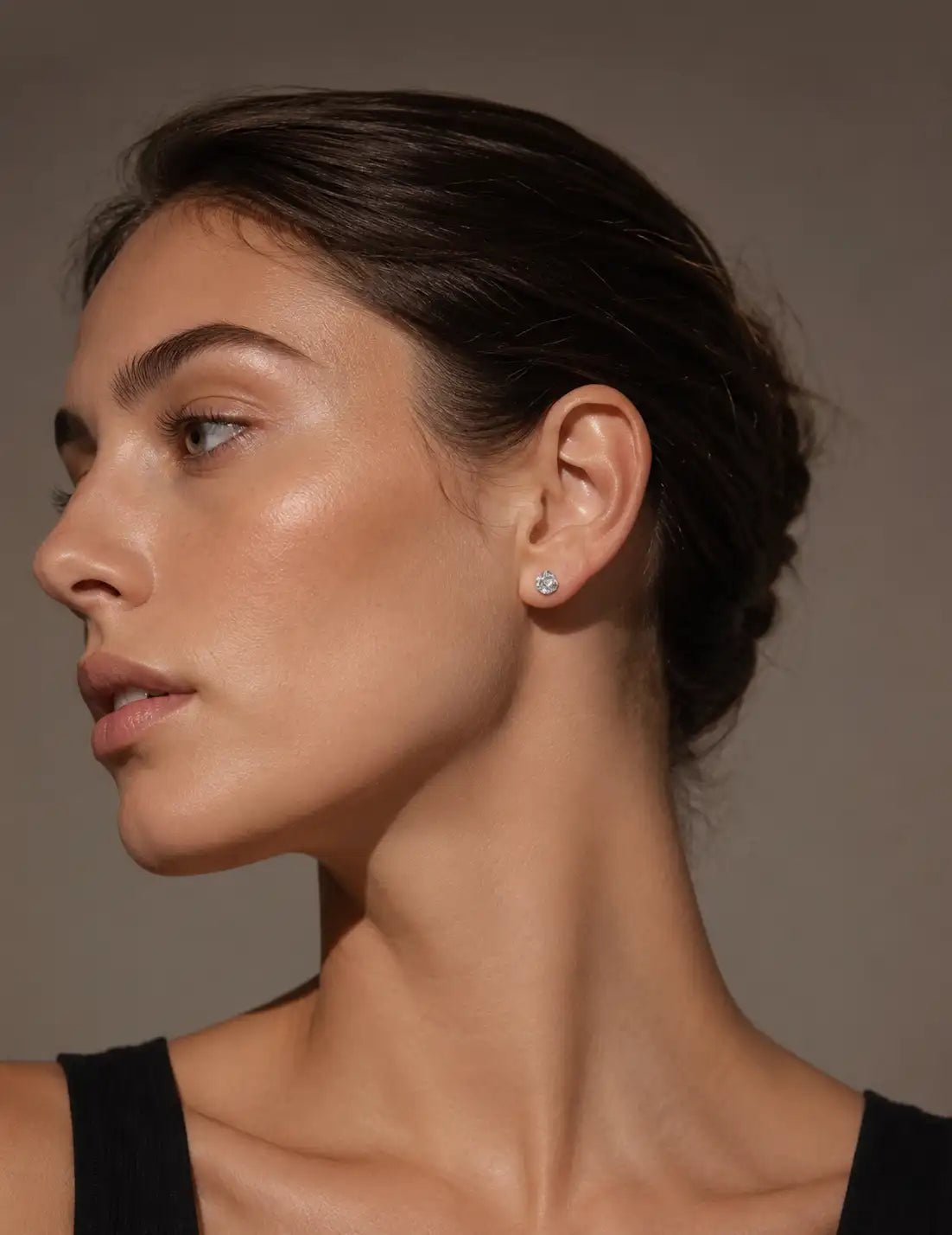 Elegant portrait of a woman wearing small textured silver stud earrings, ideal for everyday jewellery, minimalist accessories and silver earrings for women.