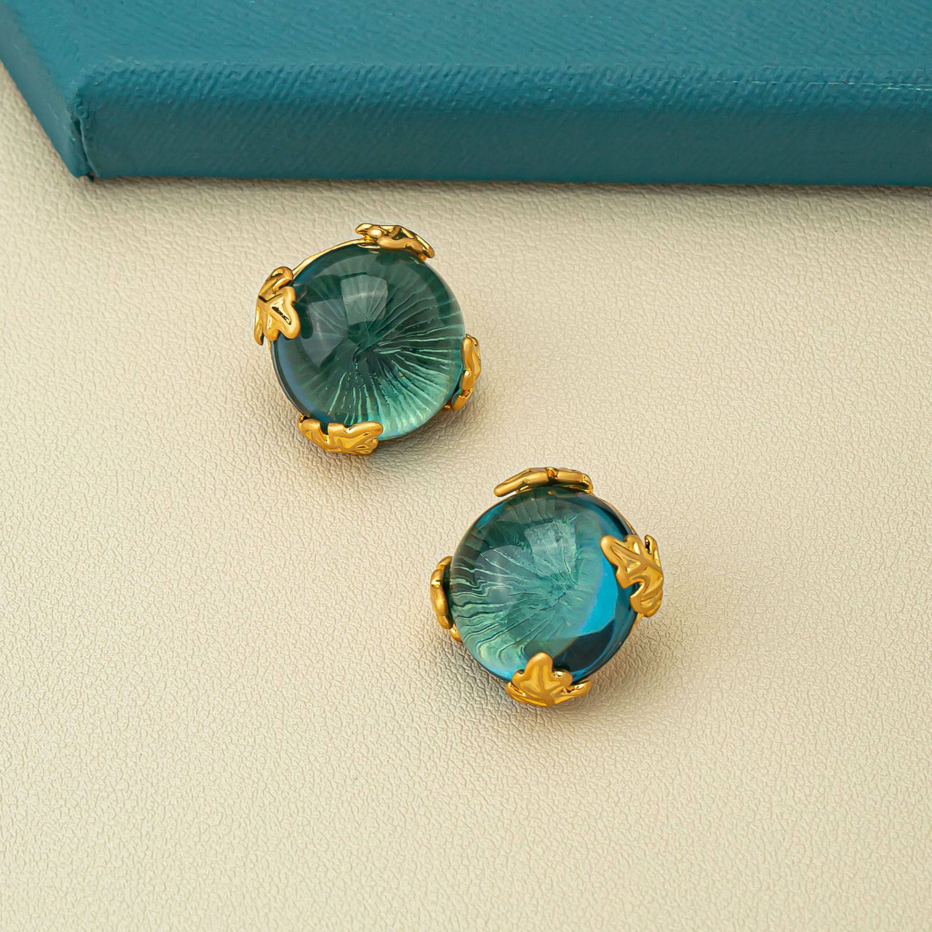 Green crystal cascade chandelier earrings in gold-tone setting, luxurious style