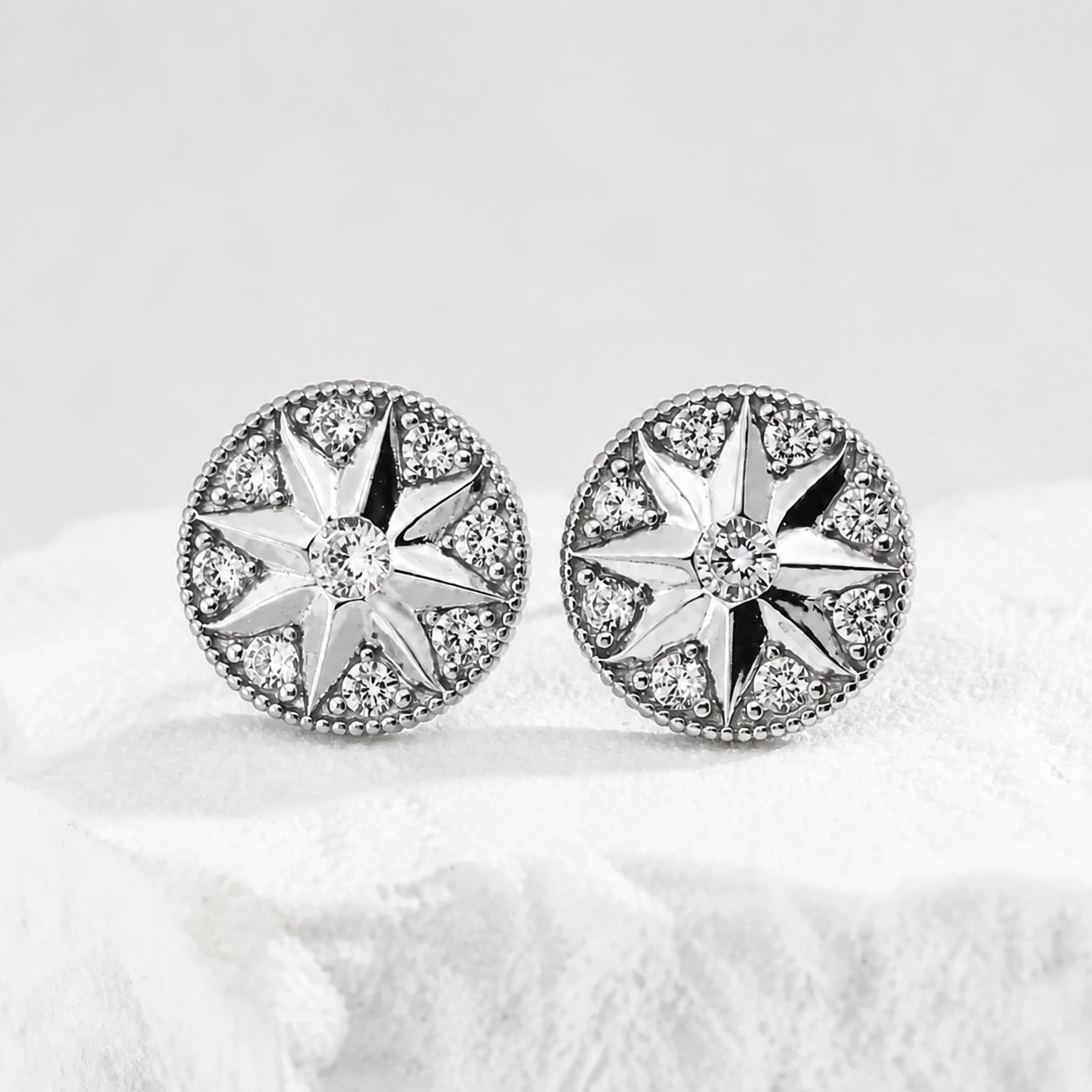 Didcot sterling silver starburst stud earrings with cubic zirconia, viewed from the right