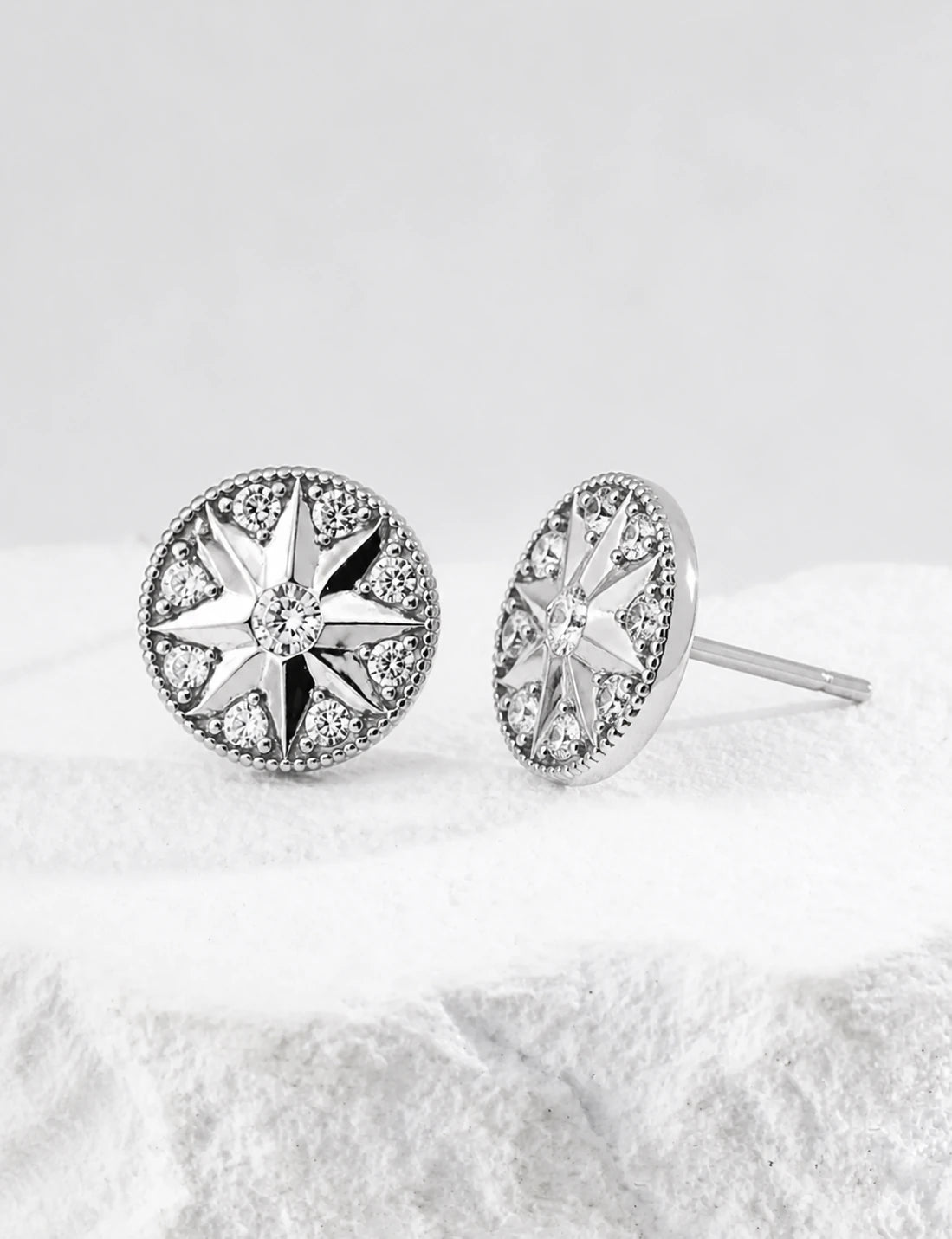 Macro close-up of Didcot sterling silver starburst stud earrings with clear cubic zirconia