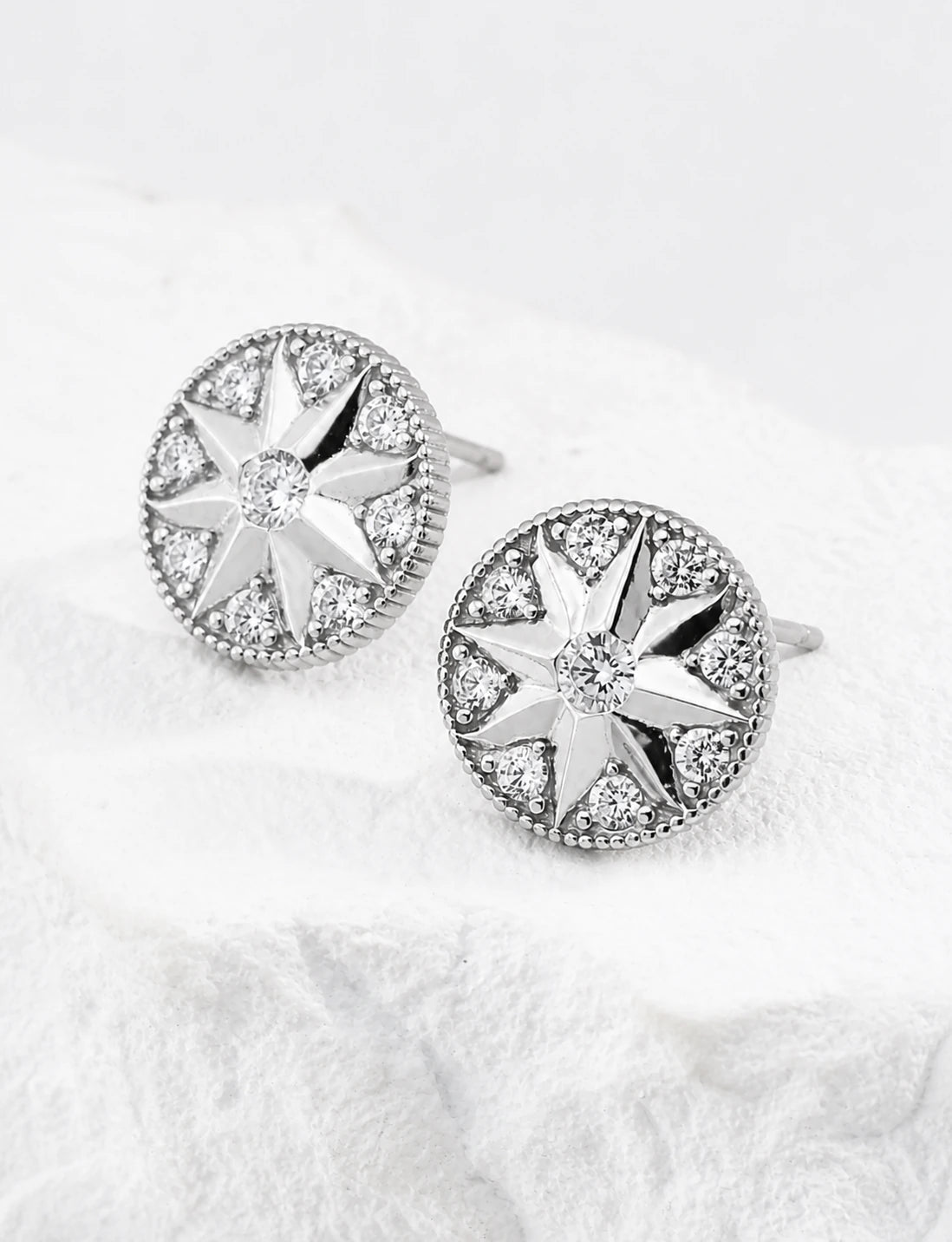 Didcot sterling silver stud earrings shown from the front and side, highlighting the setting depth