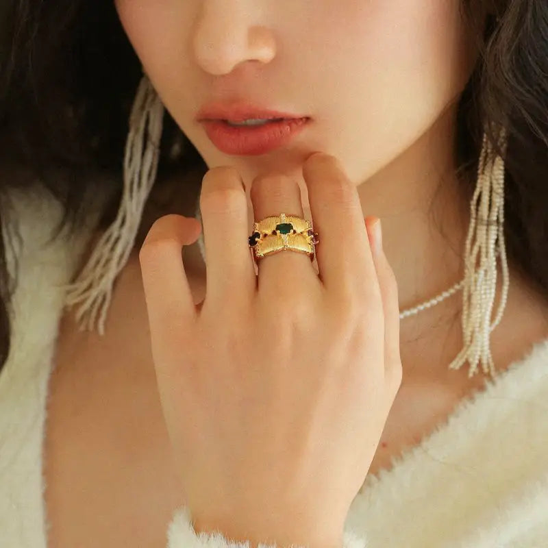 Woman wearing Radiance Gemstone Ring and gold-tone hoop earrings with pearls