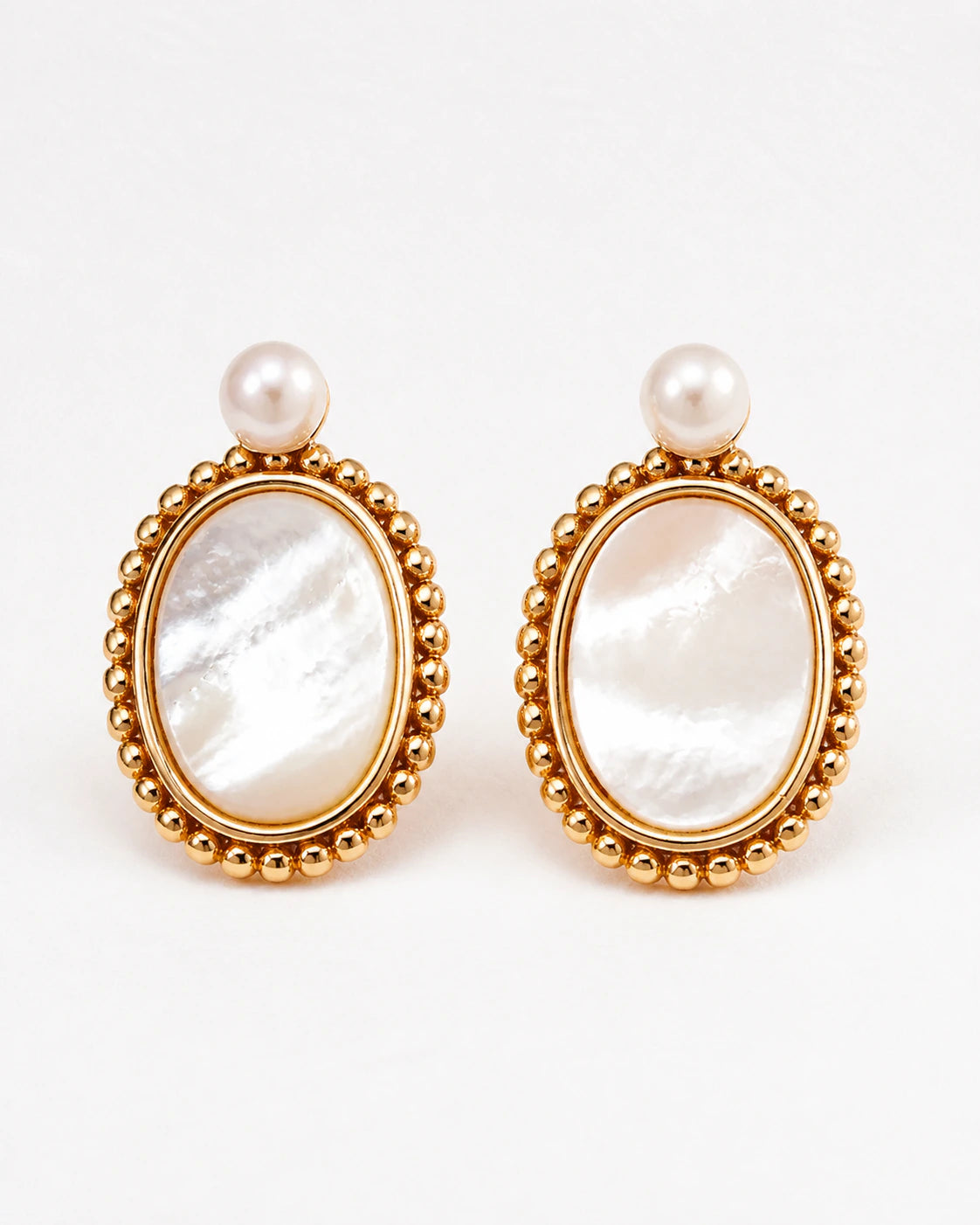 Haslemere gold mother of pearl drop earrings with pearl studs and polished beaded oval frames, front view